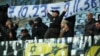 FILE - Maccabi Tel Aviv fans display yellow and blue flags of Israel and a banner inside the Arena Lublin stadium in Poland, Nov. 9, 2023, before the match. 