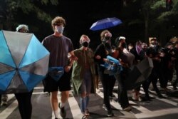 Demonstrators protest near the Charlotte Convention Center, the site of the Republican National Convention, in Charlotte, North Carolina, Aug. 23, 2020.