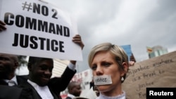 Zimbabwean lawyers carry placards as they march to demand justice for people detained in jail and others facing fast-track trials following recent protests in Harare, Zimbabwe, Jan. 29, 2019. 