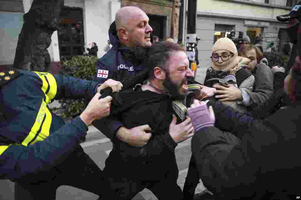 Police detain a protester during a rally against the results of the parliamentary elections amid allegations that the vote was rigged in Tbilisi, Georgia. (AP Photo/Zurab Tsertsvadze)