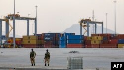 FILE - Somaliland security personnel stand watch in front of shipping containers being stored at Berbera Port on August 31, 2021.