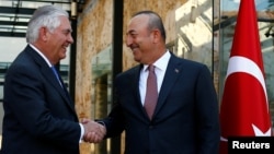 FILE - U.S. Secretary of State Rex Tillerson, left, meets with Turkish Foreign Minister Mevlut Cavusoglu in Istanbul, Turkey, July 9, 2017.
