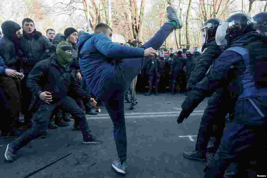 Activists of Ukrainian far-right movements attack police officers during a demonstration against land reform in Kyiv, Ukraine.