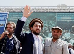 FILE - Ahmad Massoud, son of Afghanistan's slain anti-Soviet resistance hero Ahmad Shah Massoud, waves as he arrives to attend a gathering in Bazarak, Panjshir province, Afghanistan, Sept. 5, 2019.