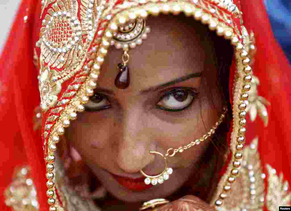 A Muslim bride watches during a mass wedding ceremony in Ahmedabad, India. A total of 111 Muslim couples took their vows during the ceremony.