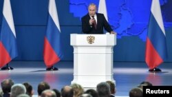 Russian President Vladimir Putin addresses the Federal Assembly, including the State Duma parliamentarians, members of the Federation Council, regional governors and other high-ranking officials, in Moscow, Feb. 20, 2019.