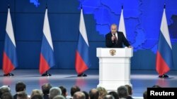 Russian President Vladimir Putin addresses the Federal Assembly, including the State Duma parliamentarians, members of the Federation Council, regional governors and other high-ranking officials, in Moscow, Feb. 20, 2019. 