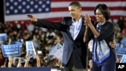 President Barack Obama and first lady Michelle Obama muster support for Democratic candidates during a rally at Ohio State University in Columbus, Ohio, 17 Oct. 2010.