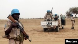 FILE - U.N. peacekeepers stand guard in the northern town of Kouroume, Mali, May 13, 2015.