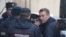 Russian opposition leader Alexei Navalny is escorted upon his arrival for a hearing after being detained at the protest against corruption, at the Tverskoi court in Moscow, Russia, March 27, 2017. 
