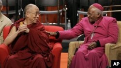 The Dalai Lama, left, sits with Archbishop Desmond Tutu, of South Africa, Tuesday, April 15, 2008 prior to speaking at the University of Washington in Seattle. The event took place on the final day of a five-day visit by the Dalai Lama to Seattle centere