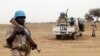 FILE - UN peacekeepers stand guard in the northern town of Kouroume, Mali.