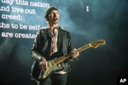 The Edge of U2 performs at the Bonnaroo Music and Arts Festival, June 9, 2017, in Manchester, Tenn. The Edge, whose name is David Evans, received the Les Paul Spirit Award before the band's set.