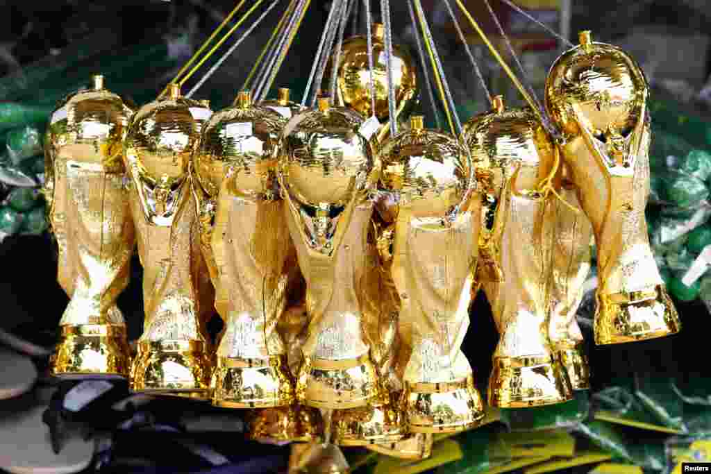 Souvenirs of the World Cup soccer trophy are put on sale in a shop in Ribeirao Preto, 336 km northwest of Sao Paulo, June 13, 2014.&nbsp;