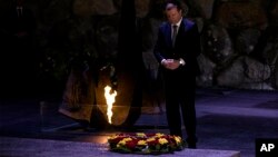 Lithuania's Prime Minister Saulius Skvernelis pays his respects at a ceremony at the Hall of Remembrance at the Yad Vashem Holocaust Memorial in Jerusalem, Tuesday Jan. 29, 2019. 