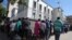 Residents queue to withdraw cash at a local bank in Harare, Zimbabwe, May 5, 2016.