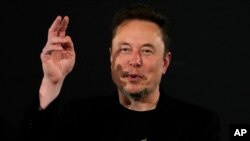 FILE - Elon Musk, owner of social media platform X, gestures during an event with Britain's Prime Minister Rishi Sunak in London on November 2, 2023.