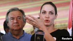 The U.N. refugee agency's special envoy, actress Angelina Jolie, speaks during a news conference with U.N. High Commissioner for Refugees (UNHCR) Antonio Guterres (L) at a refugee camp in Jordan, Sept 11, 2012.