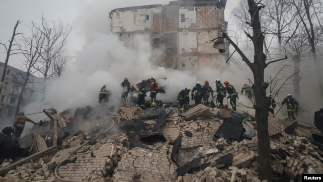 Rescuers work at a site of a residential building heavily damaged during a Russian missile attack, amid Russia's attack on Ukraine, in Kharkiv, Ukraine, Jan. 23, 2024.