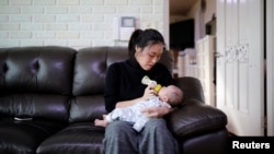 Kim Mi-sung feeds her baby son at their home in Seoul, South Korea, Dec. 19, 2018. The country's fertility rate fell to 0.95 in 2018.