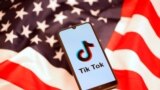 Tik Tok logo is displayed on a smartphone on the U.S. flag in this illustration 