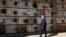 Rev. Mario Carminati walks in a cemetery in Seriate, near Bergamo, Italy, Sunday, Sept. 27, 2020. As the world counts more than 1 million COVID victims, the quiet of everyday life and hum of industry has returned to Bergamo. (AP Photo/Antonio Calanni)