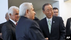 United Nations Secretary-General Ban Ki-moon (R) speaks with Greek Cypriot leader Dimitris Christofias (C) and his Turkish Cypriot counterpart Dervis Eroglu (L) following their meetings at United Nations headquarters in New York, January 25, 2012
