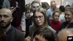 Russian socialite and opposition member Kseniya Sobchak waits outside a court where Russian theater and film director Kirill Serebrennikov attends a hearing, in Moscow, Oct. 17, 2017.