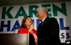 Republican candidate for Georgia's sixth district congressional seat Karen Handel stands with her husband Steve as she declares victory during an election-night watch party, June 20, 2017, in Atlanta, Georgia.