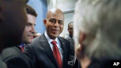 Haiti's President-elect Michel Martelly greets supporters after holding a news conference at the National Press Club in Washington, Apr 21 2011