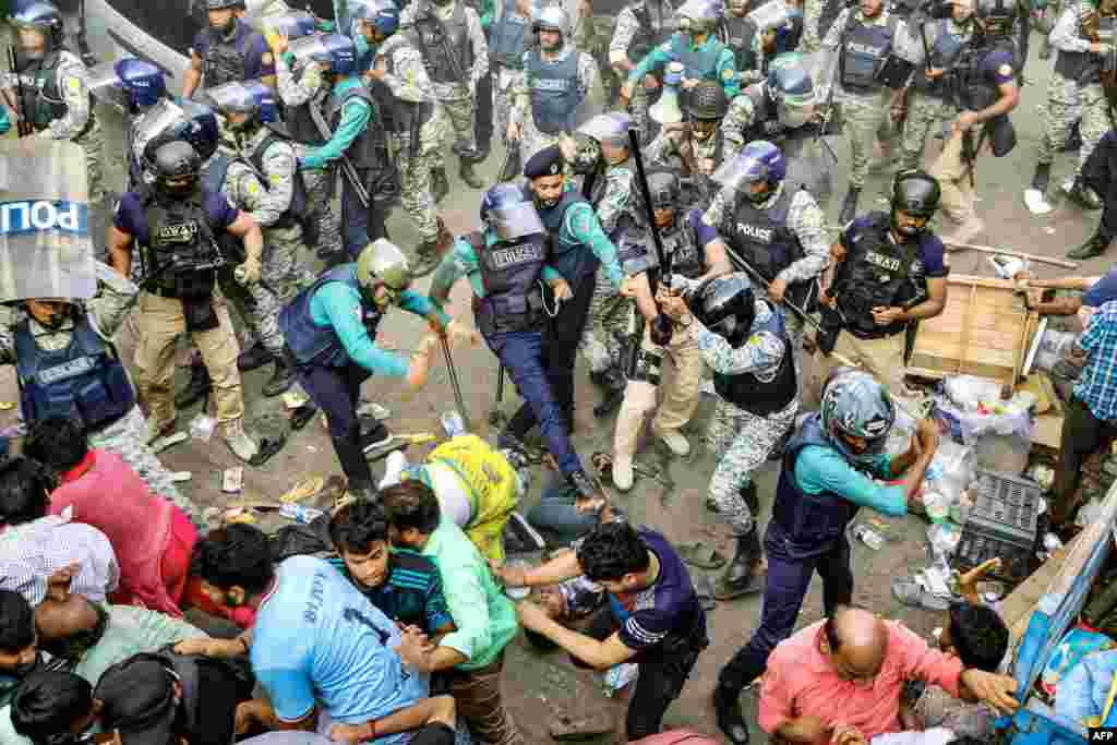 Police personnel baton-charge protesting supporters of Chinmoy Krishna Das Brahmachari, a jailed Hindu monk leader, during a demonstration after court denied his bail in Chittagong, Bangladesh.