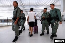 Riot police patrol inside Hong Kong International Airport in Hong Kong, Sept. 22, 2019.