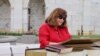 Woman reads Bible at the 27th U.S Capitol Bible Marathon, Washington, DC, May 4, 2016. (Y. Chen/VOA)