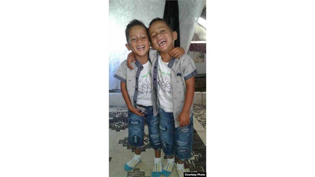 Khaled's mother took this photo of his twin brothers, age 6, in their tent.