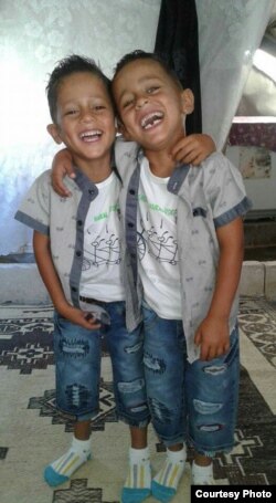 Khaled's mother took this photo of his twin brothers, age 6, in their tent.