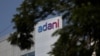 FILE - The logo of the Adani Group is seen on the facade of its Corporate House on the outskirts of Ahmedabad, India, Nov. 21, 2024. 