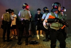 Riot police officers search people and their belongings, after an anti-extradition bill protest, at Po Lam Mass Transit Railway station, in Hong Kong, Sept. 5, 2019.