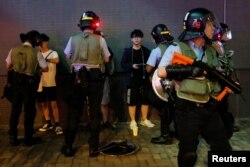 Riot police officers search people and their belongings, after an anti-extradition bill protest, at Po Lam Mass Transit Railway station, in Hong Kong, Sept. 5, 2019.