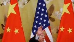 U.S. President Donald Trump waves during joint statements with China's President Xi Jinping at the Great Hall of the People in Beijing, China, November 9, 2017. REUTERS/Thomas Peter/File Photo