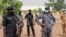 FILE- Security forces guard the Government Girls Junior Secondary School where more than 300 girls were abducted by gunmen, in Jangebe town, Zamfara state, northern Nigeria, Feb. 28, 2021.