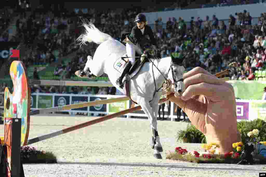 South African Cara Bianca Frew rides Leopold Pierreville during the individual jumping competition of the 2014 FEI World Equestrian Games, in the northwestern French city of Caen.