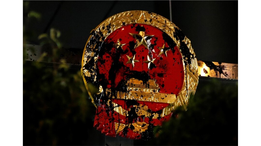 The National Emblem of the People's Republic of China is seen vandalized on the Chinese Liaison Office after a march to call for democratic reforms, in Hong Kong, July 22, 2019.