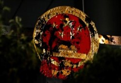 The National Emblem of the People's Republic of China is seen vandalized on the Chinese Liaison Office after a march to call for democratic reforms, in Hong Kong, July 22, 2019.