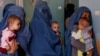 FILE - In this Aug. 26, 2019 photo, mothers hold their babies suffering from malnutrition as they wait at a UNICEF clinic in Jabal Saraj, north of Kabul, Afghanistan.