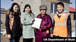 Baigalimaa Enebish, second from left, and members of her cooperative receive land titles through the MCC's Property Rights project in Mongolia. (Courtesy MCC)