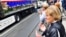 Bosnian Muslims, citizens of Sarajevo, pray near a truck, carrying the remains of 35 newly identified victims of Srebrenica massacre, while it makes a short stop in Sarajevo city center, July 9, 2018.