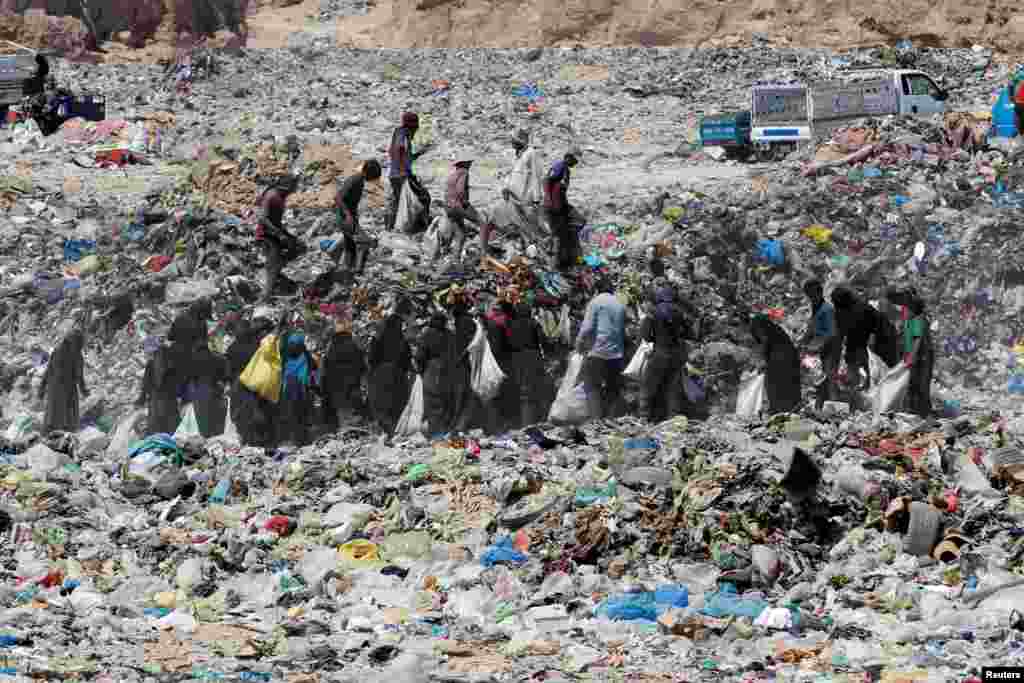 People collect recyclable items at a garbage dump in the holy city of Najaf, Iraq.