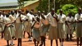 FILE - Girls take a break at the Loreto Secondary School, the region's only all-girls boarding school where staff require each girl's guardian to sign a form promising not to remove the child from school until graduation, in the town of Rumbek, South Sudan, July 30, 2017.