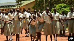 FILE - Girls take a break at the Loreto Secondary School, the region's only all-girls boarding school where staff require each girl's guardian to sign a form promising not to remove the child from school until graduation, in the town of Rumbek, South Sudan, July 30, 2017.