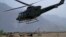 FILE - A Pakistan army helicopter take off as troops wait for clearance to use heavy artillery towards alleged militants hideouts in the mountain ranges along the Afghan border, June 1, 2011.